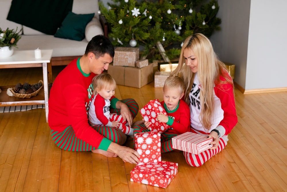 Matching family Christmas hoodies and pajamas for festive celebration Family wearing cozy matching Christmas pajamas and hoodies at home